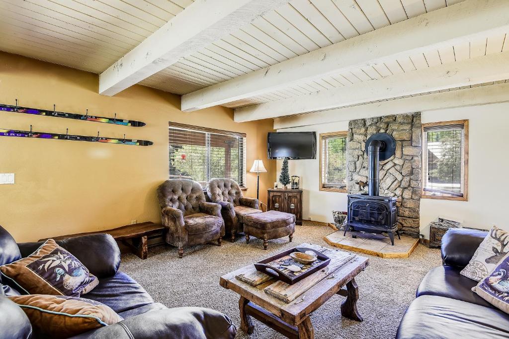 a living room with couches and a wood stove at San Juan River House in Pagosa Springs