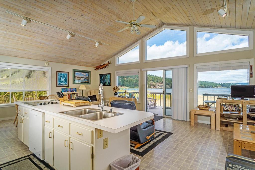 a kitchen with a sink and some windows at 57 Mud Bay in Islandale