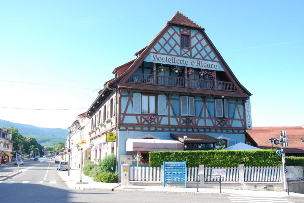 a building with a sign on the side of it at Hostellerie d'Alsace in Cernay