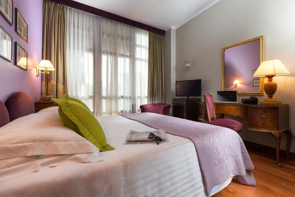 Postel nebo postele na pokoji v ubytování Hotel Fenix