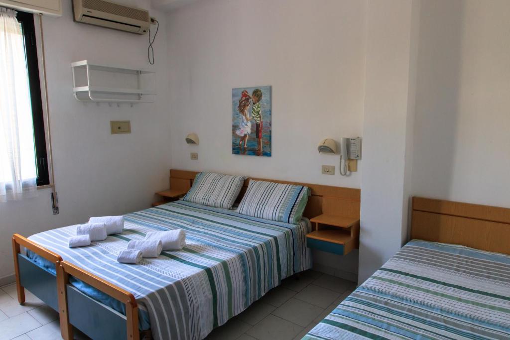 Postel nebo postele na pokoji v ubytování Hotel Riziana