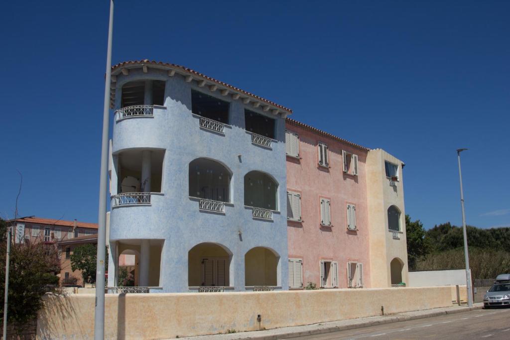 a blue building with balconies on the side of it at Appartamento l'Aurora in Santa Teresa Gallura