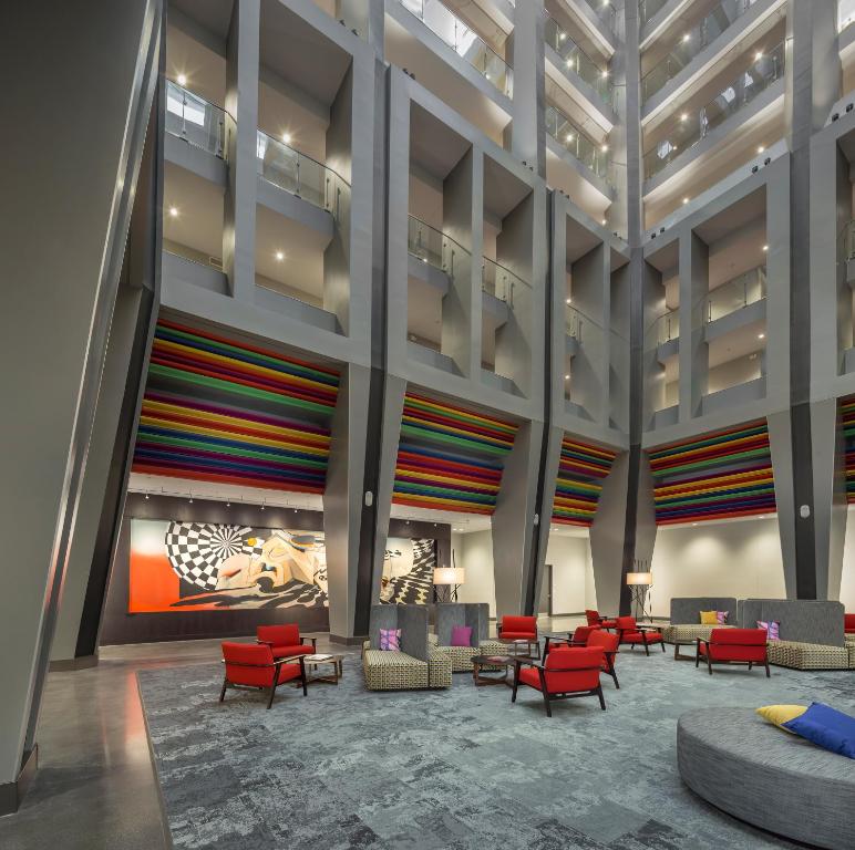 a rendering of a lobby with colorful chairs and tables at The Summit Hotel in Cincinnati