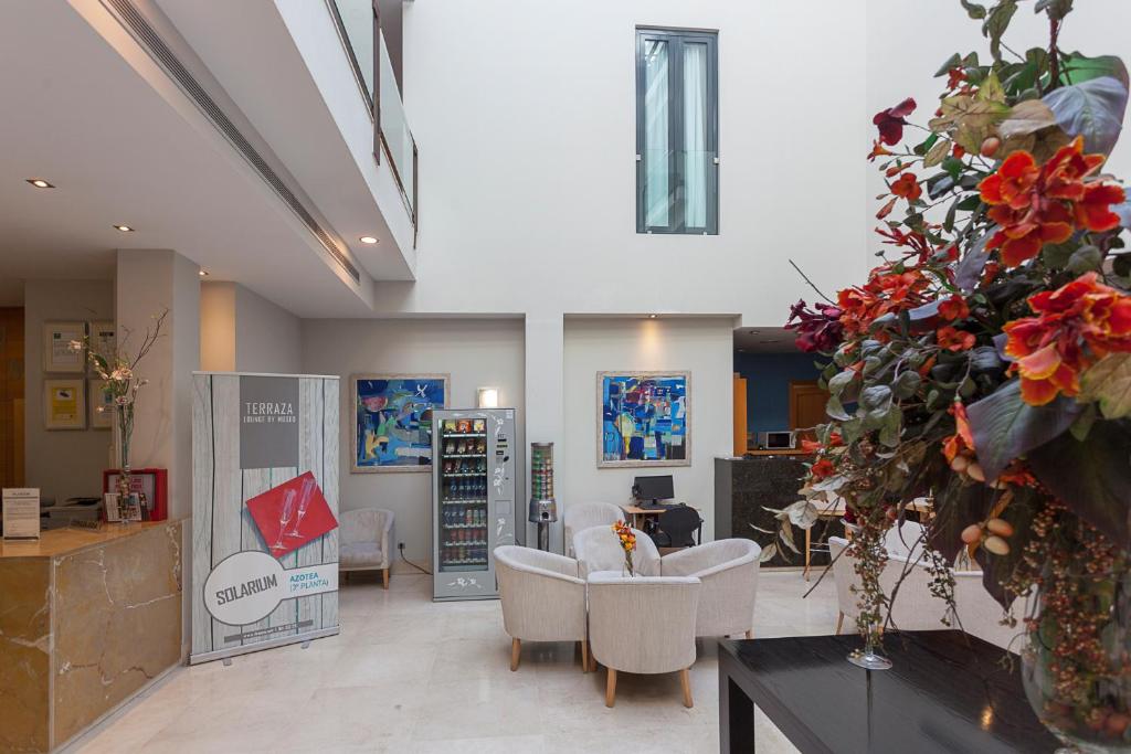Televízia a/alebo spoločenská miestnosť v ubytovaní Hotel AACR Museo