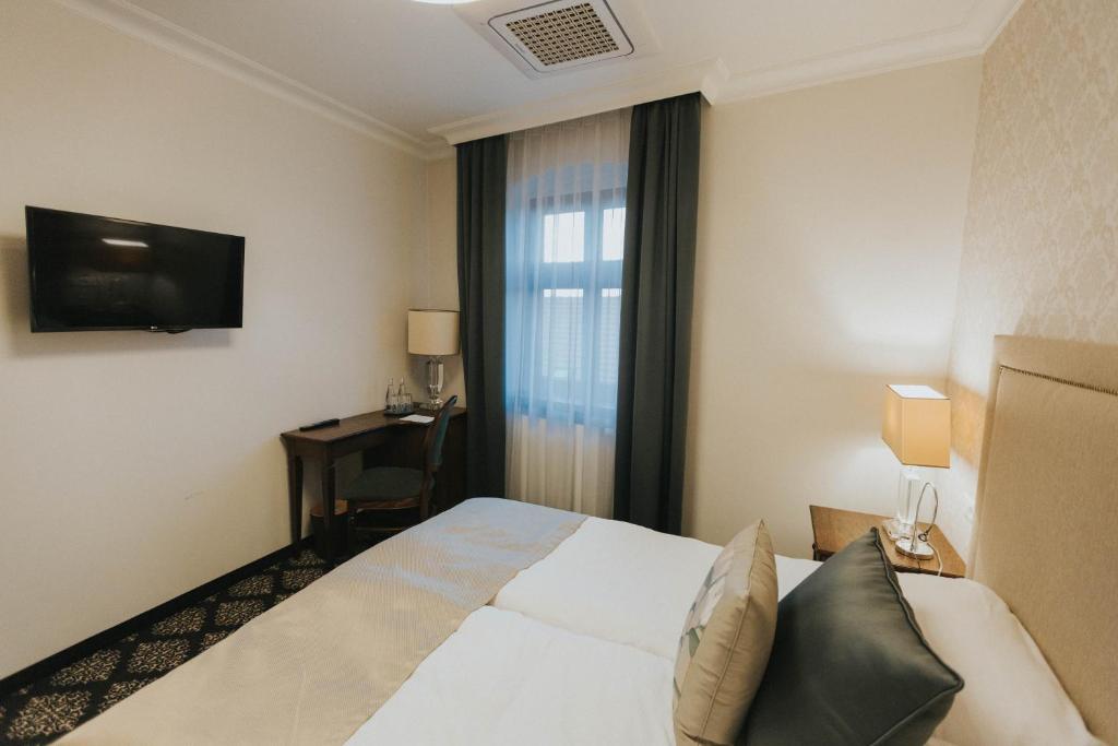 Postel nebo postele na pokoji v ubytování HG Hotel