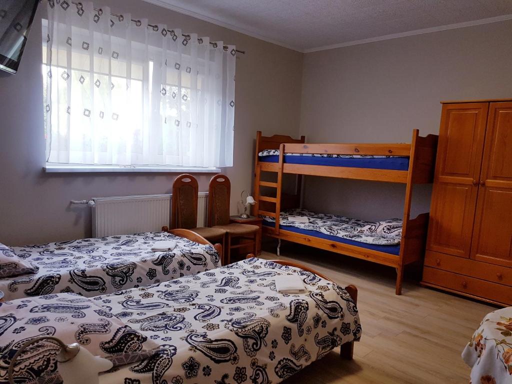 Posteľ alebo postele v izbe v ubytovaní Pokoje Adriano