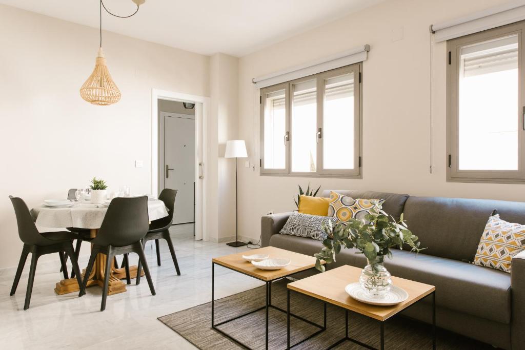 a living room with a couch and a table at Sevilla Apartments Muro in Seville
