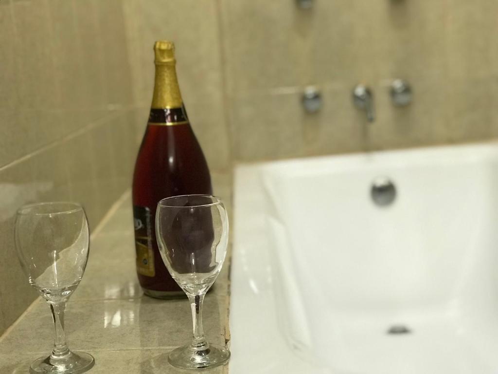 a bottle of wine and two wine glasses on a table at Real Carretero in Tapalpa