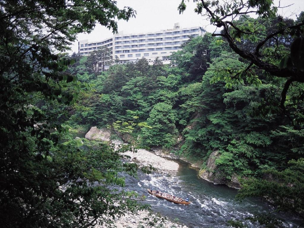 a group of people kayaking down a river at Kinugawa Royal Hotel in Nikko