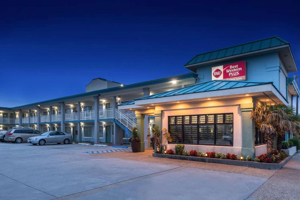 a hotel with a parking lot in front of it at Best Western Plus Holiday Sands Inn & Suites in Norfolk