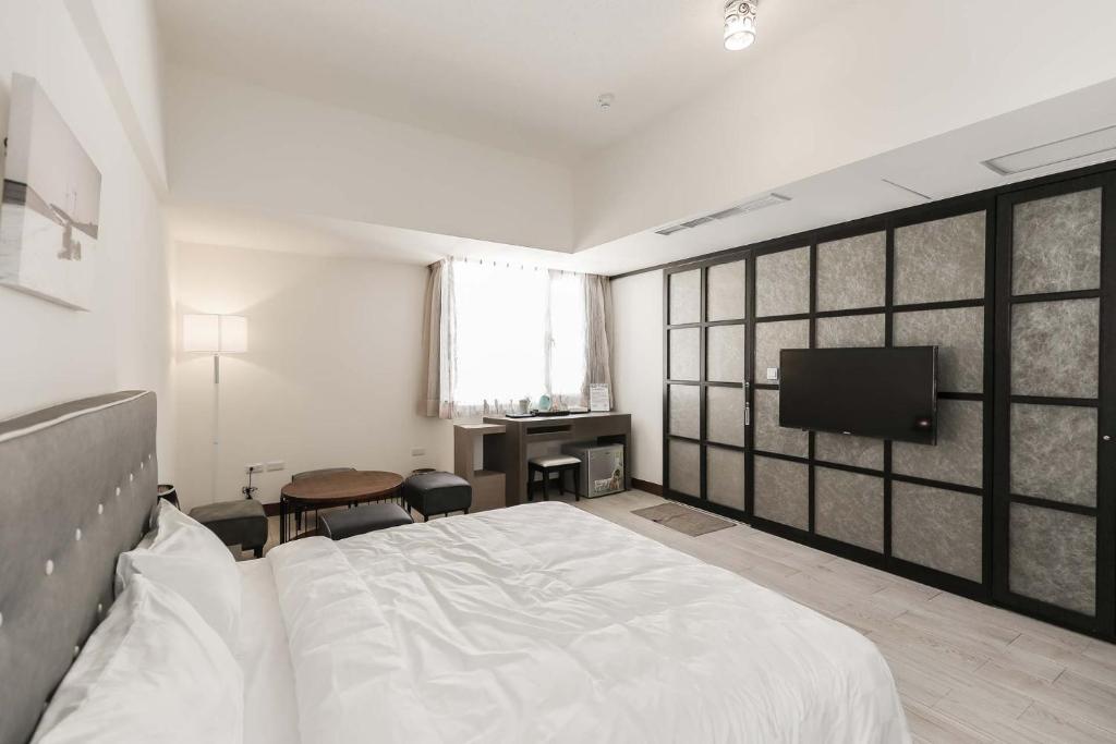 Postel nebo postele na pokoji v ubytování Tien Hsiang Lin Sea Dragon King Hotel