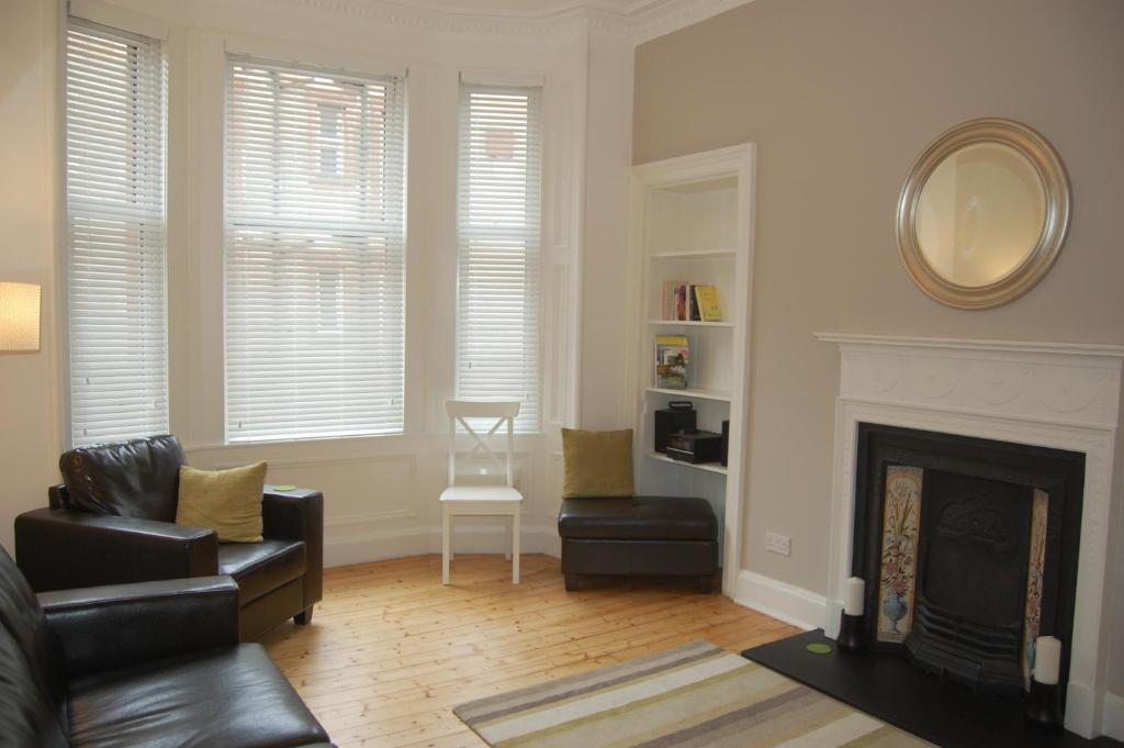 a living room with a fireplace and a mirror at Home from Home at Number 2 in Edinburgh