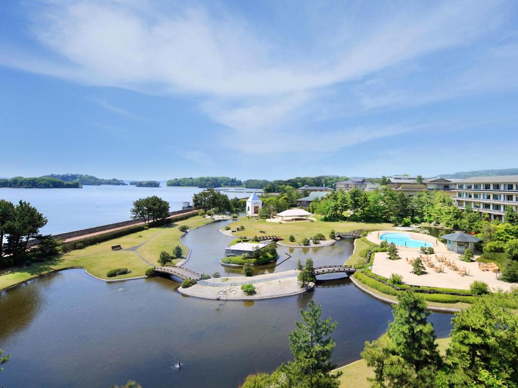 an aerial view of a river with a resort at Matsushima Ichinobo in Matsushima