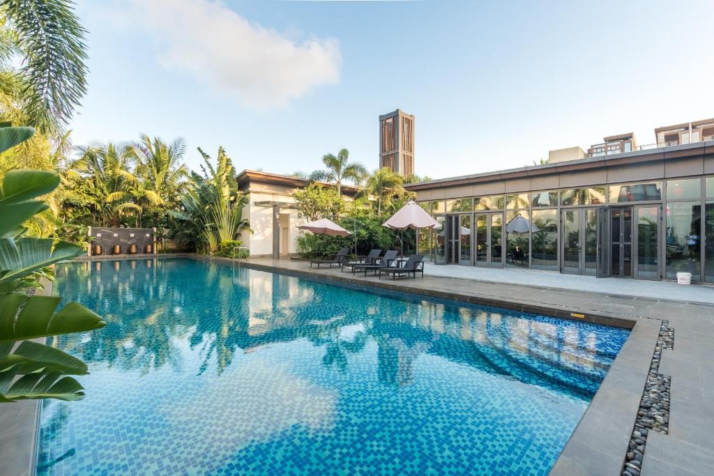 uma grande piscina em frente a um edifício em Sanya Haitang Bay Mushe Villa em Sanya