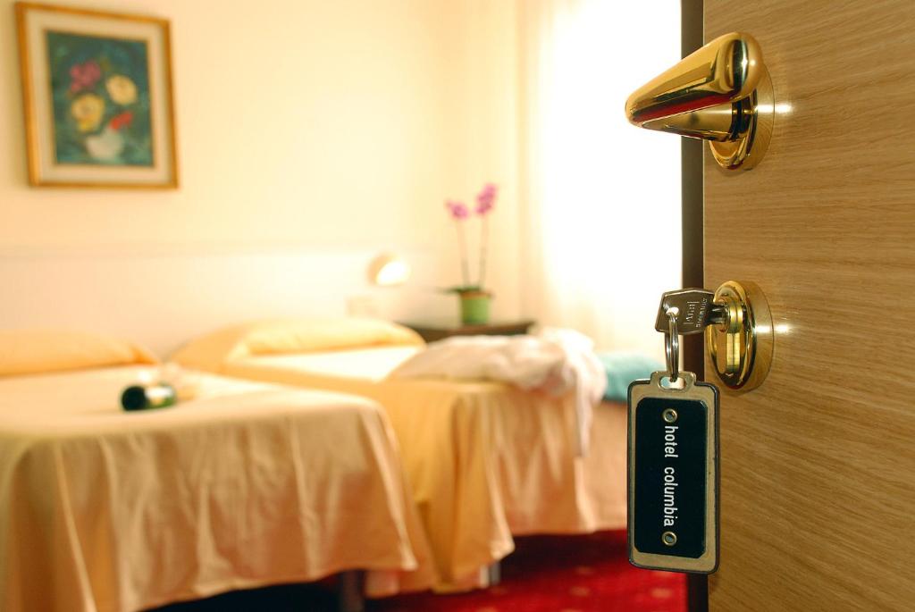 Postel nebo postele na pokoji v ubytování Hotel Columbia Terme