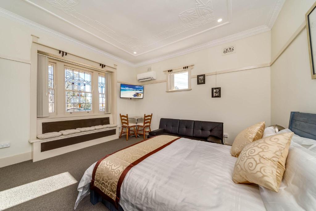 a bedroom with a large bed and a television at Marulan Stayz in Marulan
