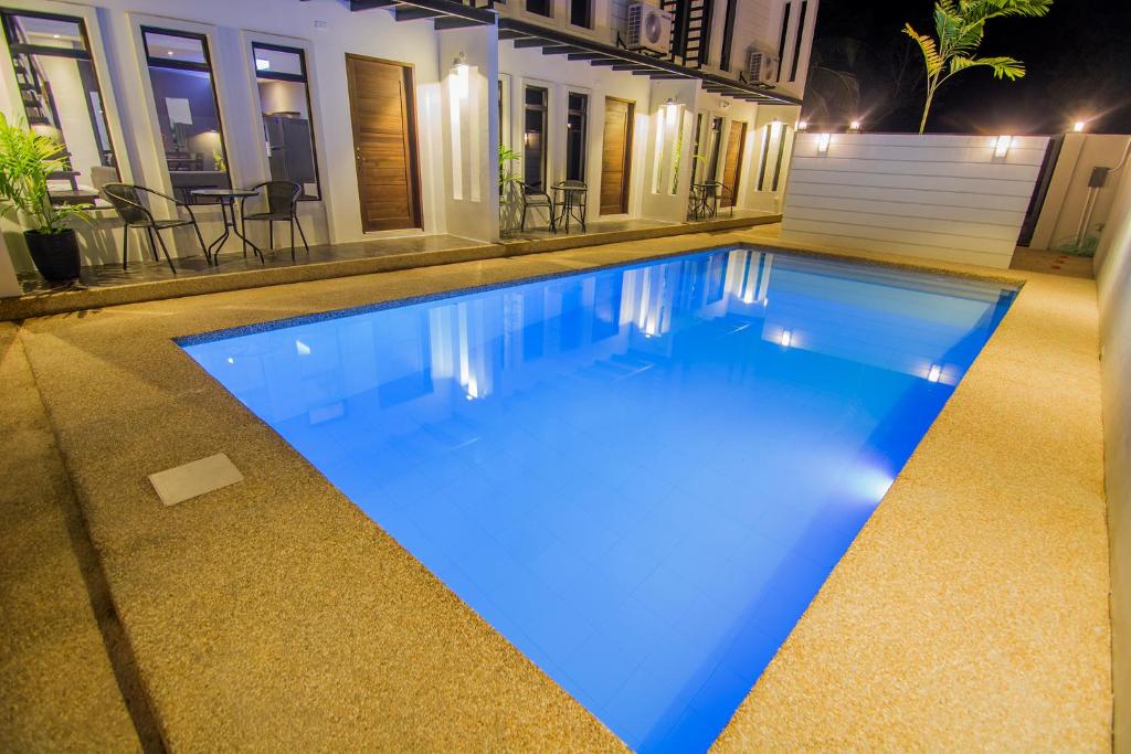 a swimming pool in a house at night at Quest Villa in Panglao