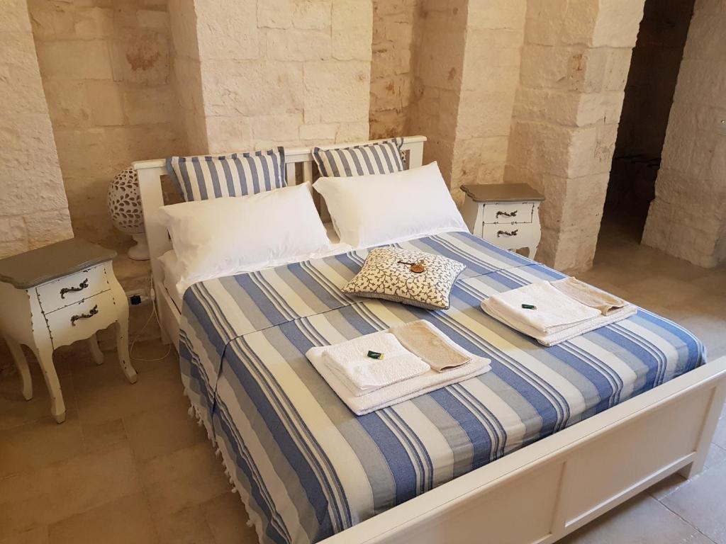 Postel nebo postele na pokoji v ubytování Trulli Petra Chiara
