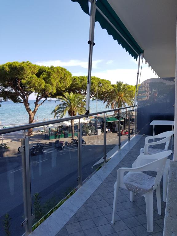 een balkon met uitzicht op een strand en palmbomen bij Alassio Sea View in Alassio