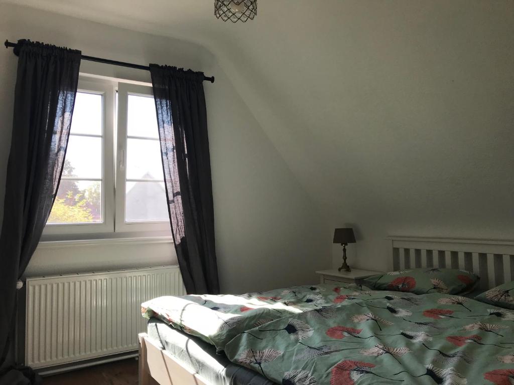 a bedroom with a bed and a window at Ferienwohnung Haltingen in Weil am Rhein