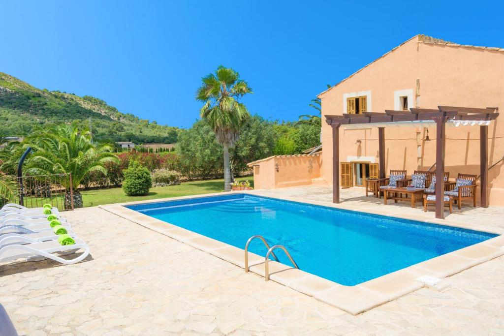 a swimming pool in front of a house at Can Corro in Alcudia