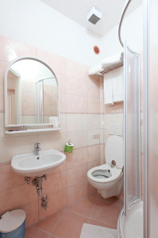a bathroom with a sink and a toilet and a mirror at Albergo Al Carugio in Monterosso al Mare