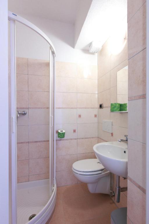 a bathroom with a shower and a toilet and a sink at Albergo Al Carugio in Monterosso al Mare
