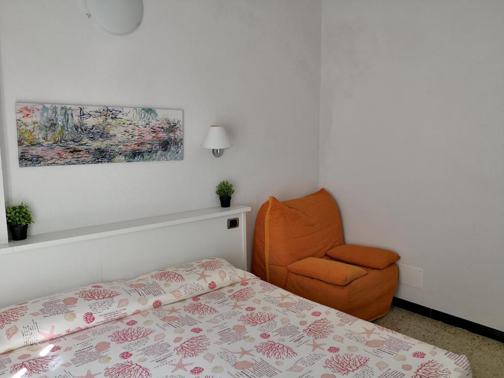 a bedroom with a bed and a chair at Albergo Al Carugio in Monterosso al Mare