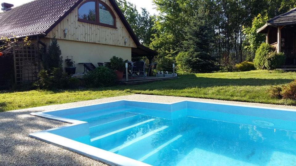a swimming pool in the yard of a house at Dom Grabowa in Gilowice