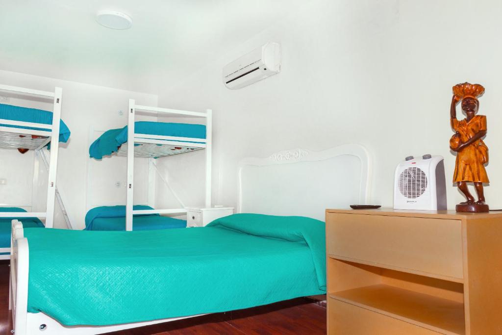 Postel nebo postele na pokoji v ubytování Hostal Casa Aborigen