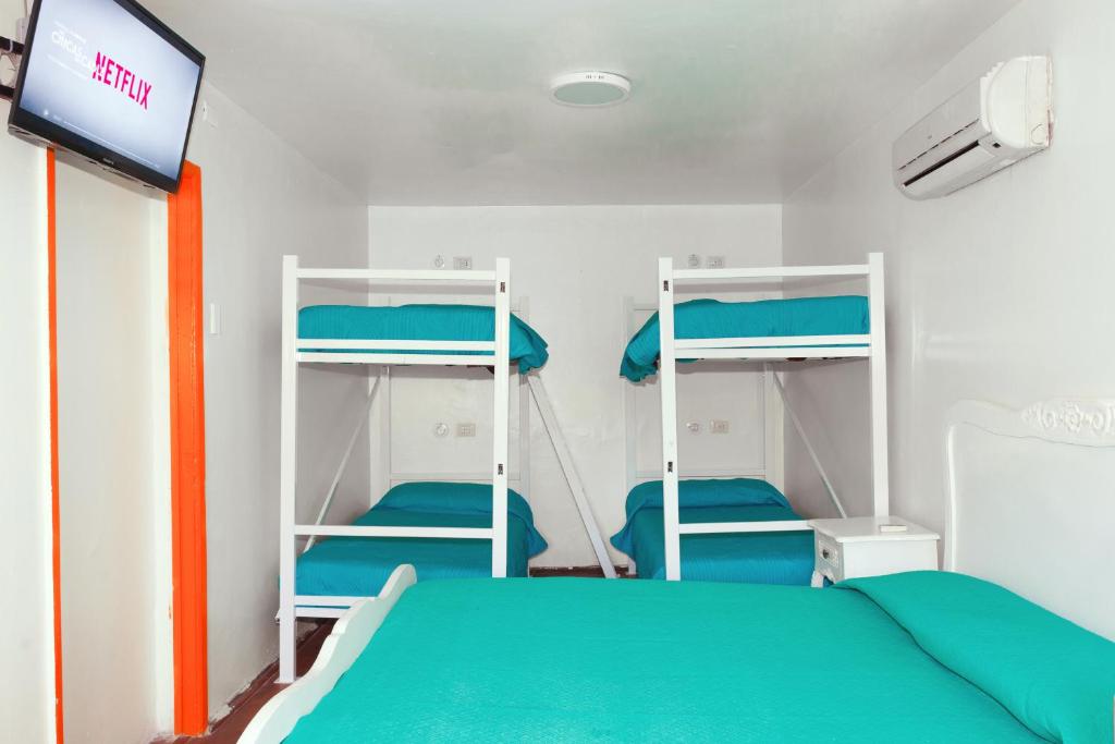 Postel nebo postele na pokoji v ubytování Hostal Casa Aborigen