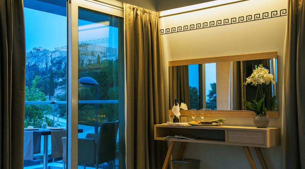 a room with a desk and a window with a view at Hotel Thissio in Athens