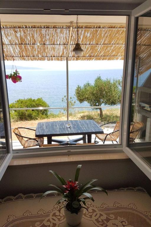 a view of the ocean from a window with a table at Korak Do Mora in Murvica