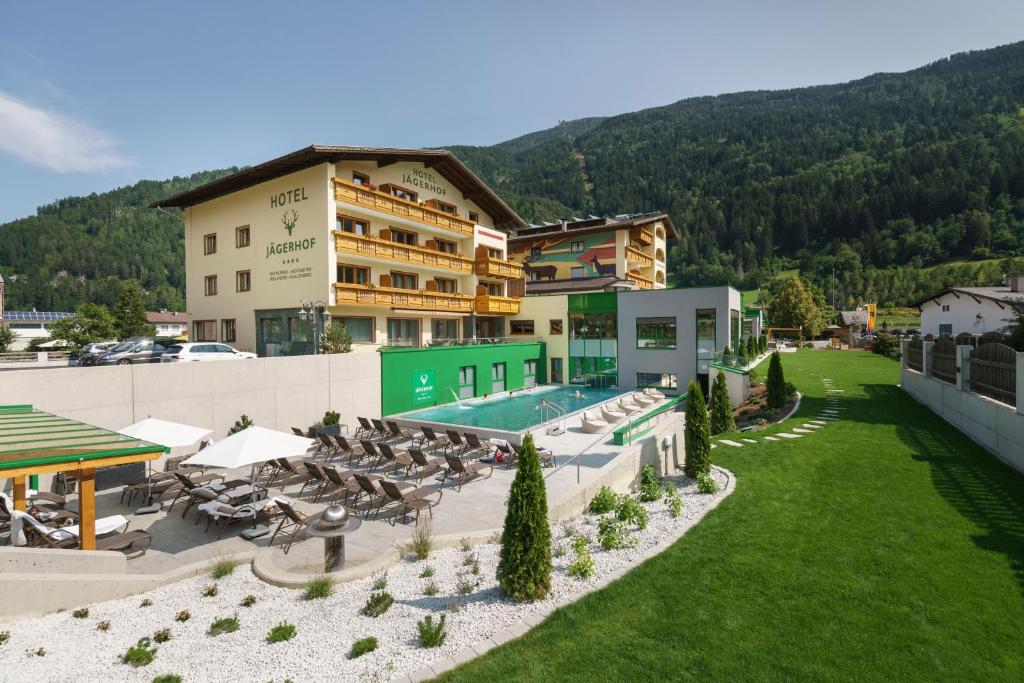 an aerial view of a hotel with a swimming pool at Hotel Jägerhof in Zams