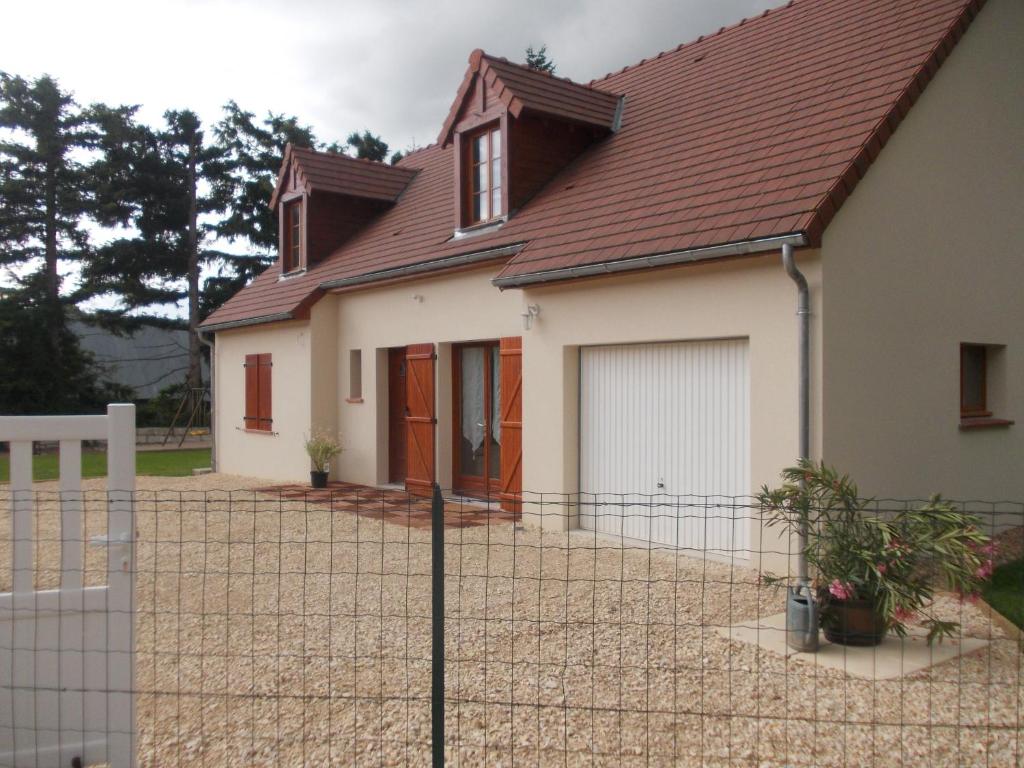 a house with a fence in front of it at Gite Du Moulin Du Vivier in Seigy