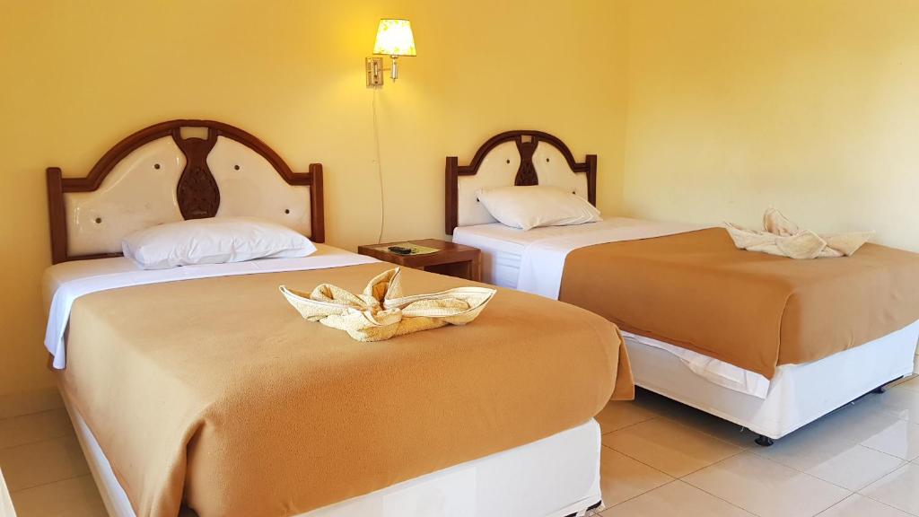 Postel nebo postele na pokoji v ubytování Hotel My Lovina