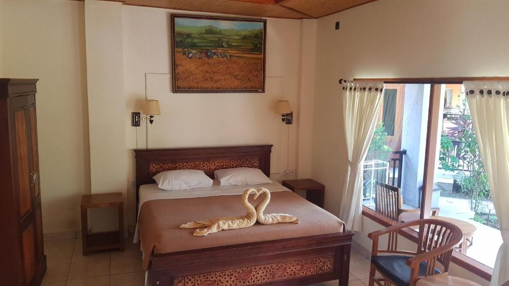 Postel nebo postele na pokoji v ubytování Hotel My Lovina