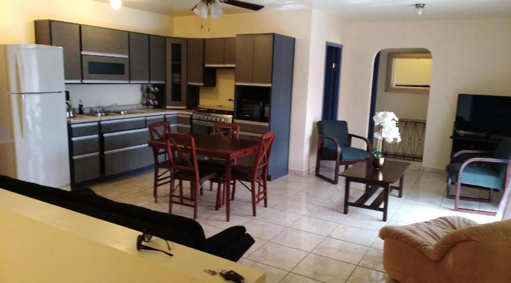 a kitchen and living room with a table and chairs at Apartment Downtown Cananea in Cananea