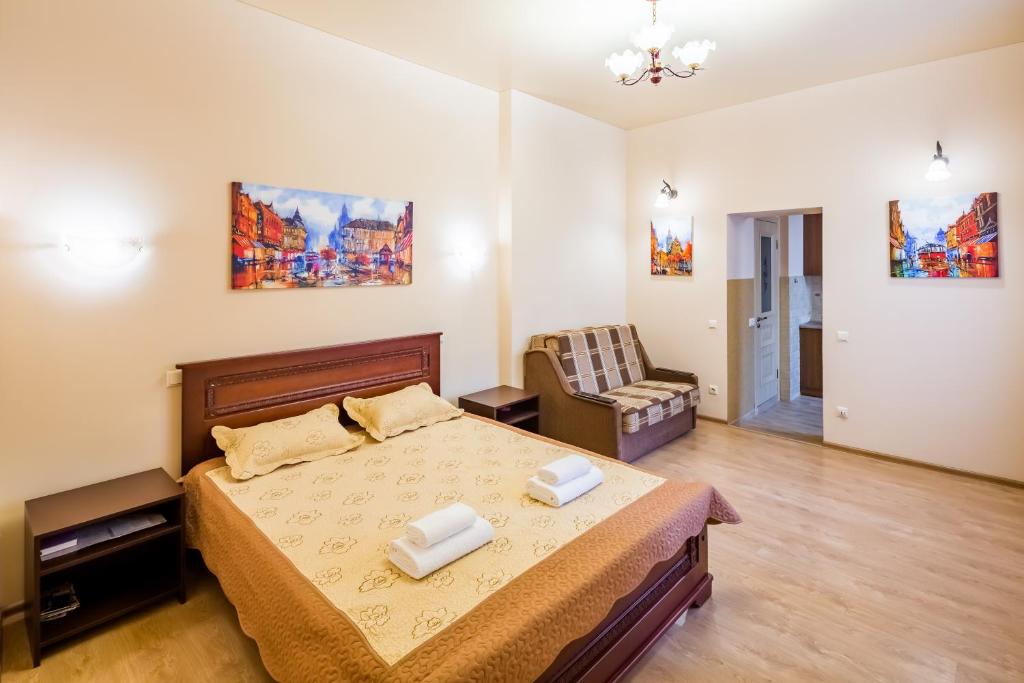 a bedroom with a bed and a chair at Apartment on Lesya Kurbasa 7 in Lviv