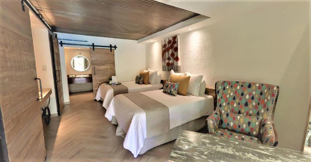 Postel nebo postele na pokoji v ubytování NEhotel Nueva Estancia