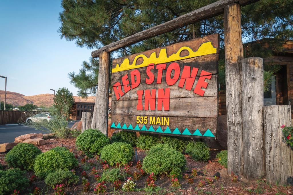 
a sign for a restaurant with a picture of a bear on it at Red Stone Inn in Moab
