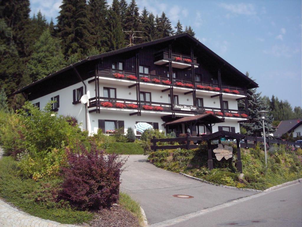 a large white building with a black roof at Pension Haus Inge in Zwiesel