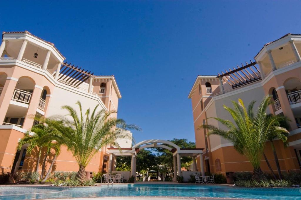 a view of two buildings and a swimming pool at Rincon Beach Resort in Rincon