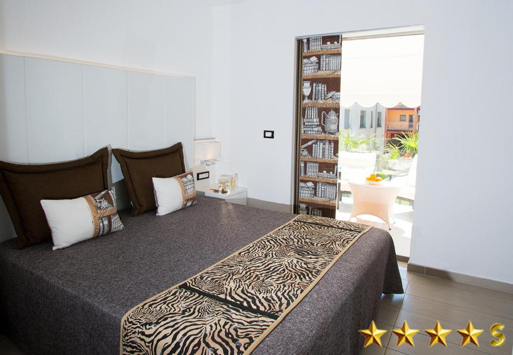 Postel nebo postele na pokoji v ubytování Hotel Rossini 4S