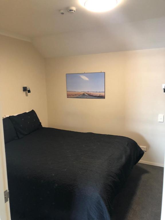 Postel nebo postele na pokoji v ubytování 555 Motel Dunedin