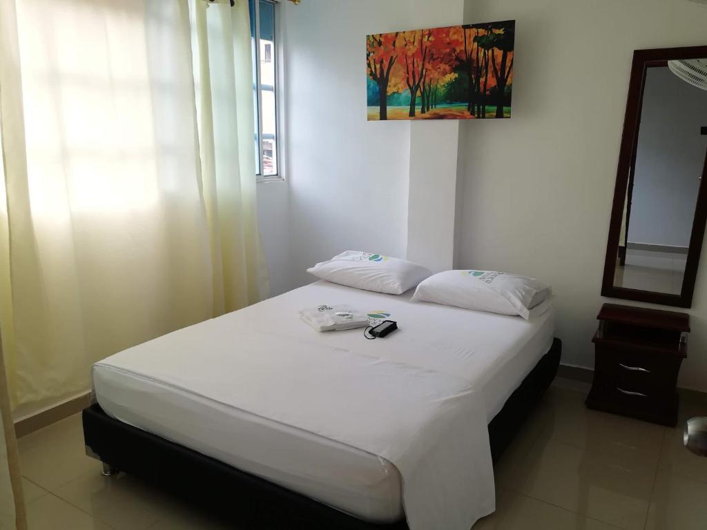 Hotel Avenida El Bosque tesisinde bir odada yatak veya yataklar