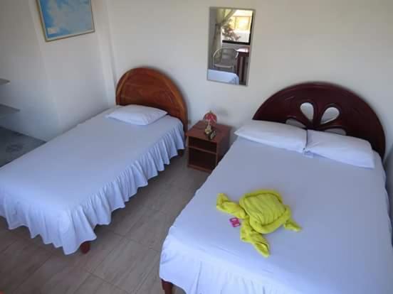 Postel nebo postele na pokoji v ubytování Hostal Insular