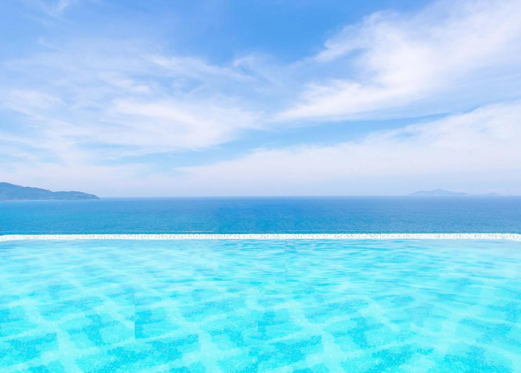 a swimming pool with the ocean in the background at Tanjung Point Residences in George Town