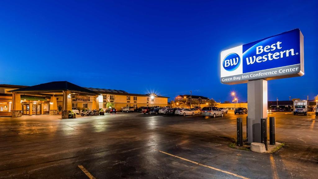 a best western sign in a parking lot at night at Best Western Green Bay Inn and Conference Center in Green Bay