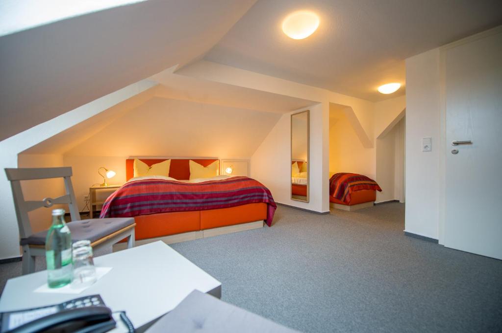 a bedroom with two beds in a attic at Gasthof Bären in Ochsenfurt